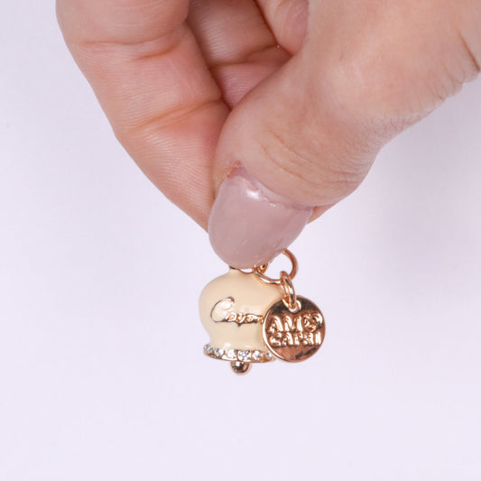 Metal pendant with cream bell written Capri