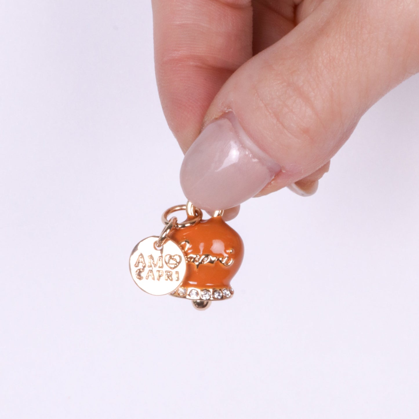 Metal pendant with orange bell written Capri