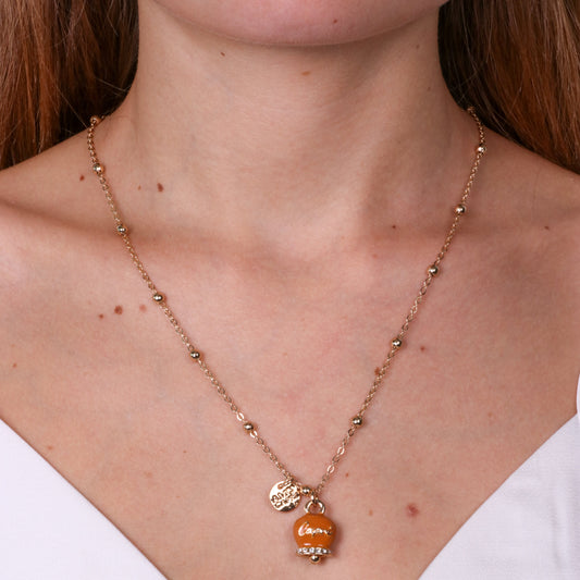 Metal necklace with orange bell written Capri