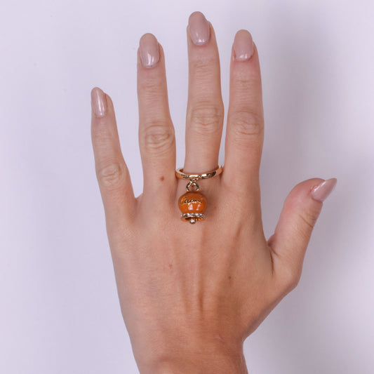 Metal ring with orange bell written Capri