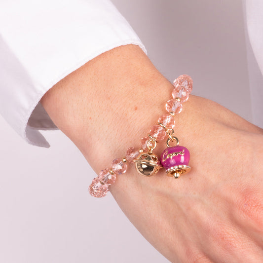 Metal bracelet with purple bell and small rattle with pink stones