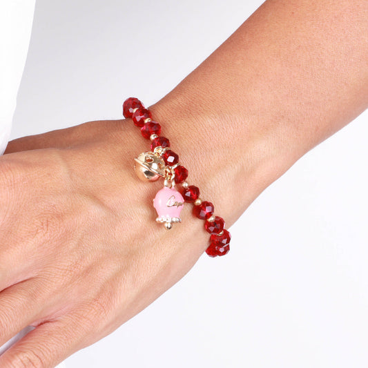 Metal bracelet with pink bell and small rattle with red stones